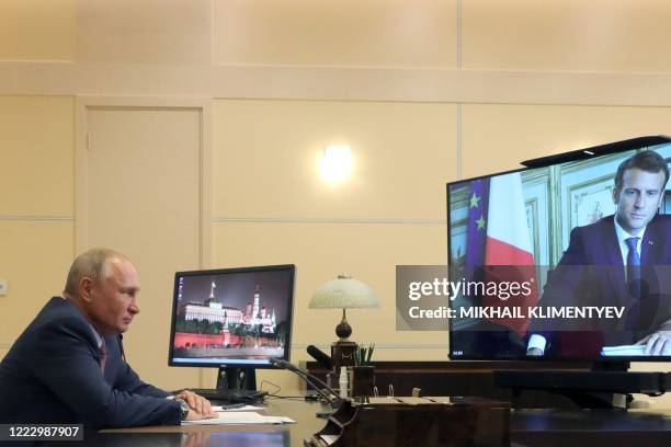 Russian President Vladimir Putin speaks with French President Emmanuel Macron during a video conference on June 26, 2020 at the Novo-Ogaryovo state...