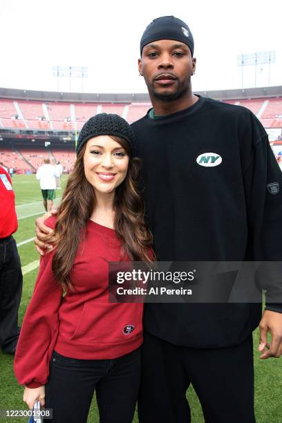 Alyssa Milano meets with New York Jets player Kerry Rhodes when she attends the New York Jets vs San Francisco 49ers game on December 7, 2008 at...