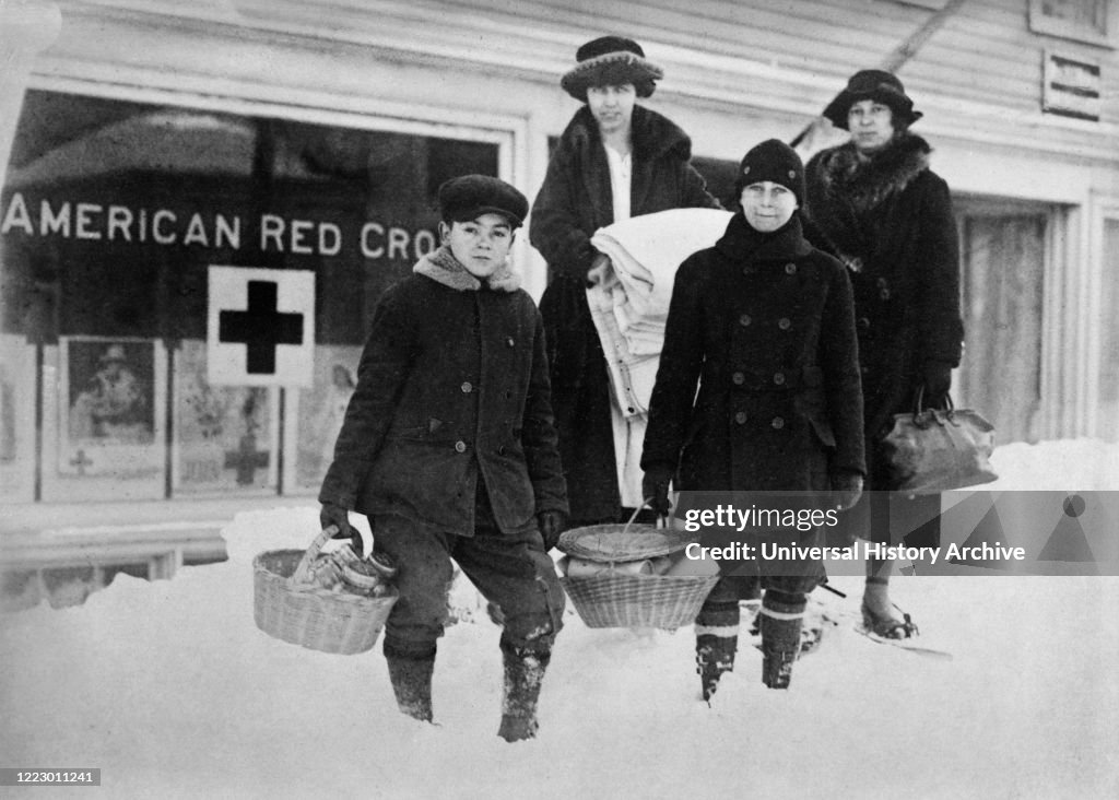 Small Group of Volunteers leaving Red Cross Headquarters with Supplies for the sick during Influenza Epidemic, Beverly, Massachusetts, USA, American National Red Cross Photograph Collection, February 1920