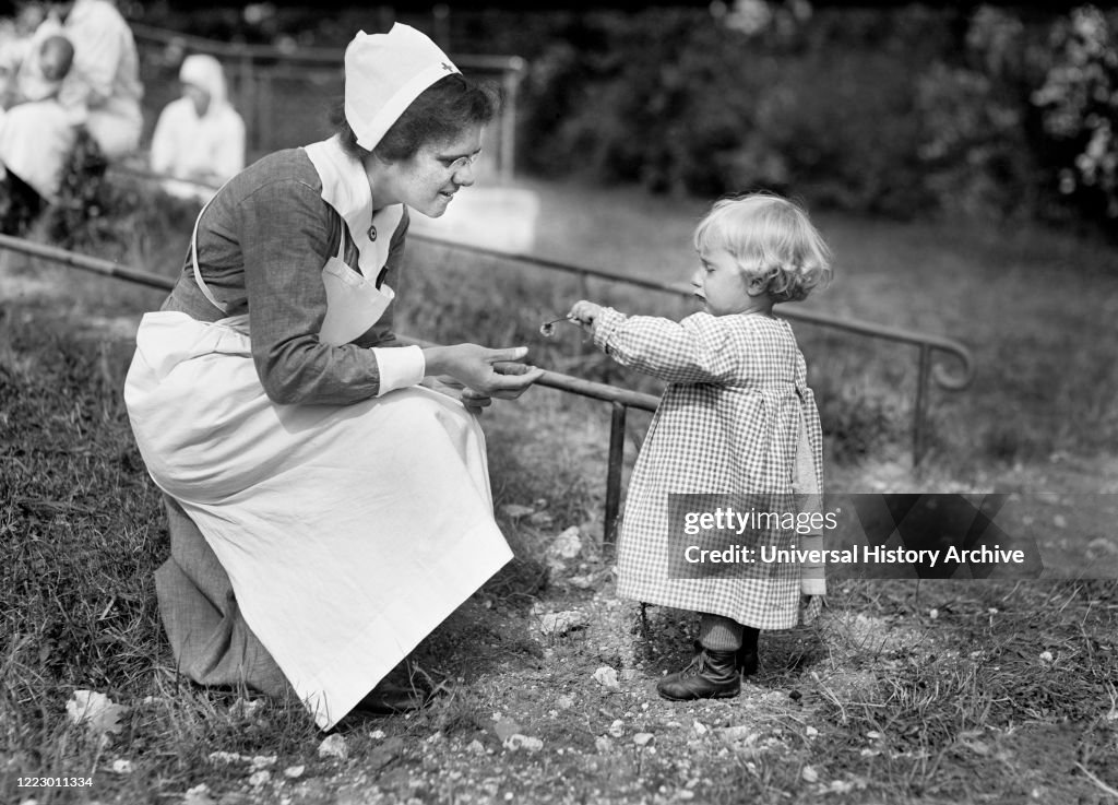 Young French Girl giving Flower to Nurse at American Red Cross Nursing Home, near Paris, France, Lewis Wickes Hine, American National Red Cross Photograph Collection