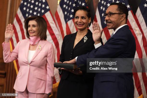 Speaker of the House Rep. Nancy Pelosi participates in a ceremonial swearing-in with Rep. Kweisi Mfume as his wife Tiffany McMillan Mfume looks on at...