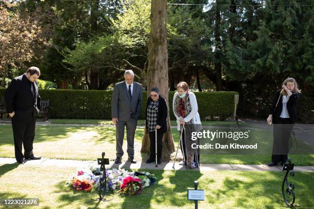 Select number of family and friends including the son of the late Eric Stonestreet, Daniel, and daughter Victoria look at flowers laid for Eric after...