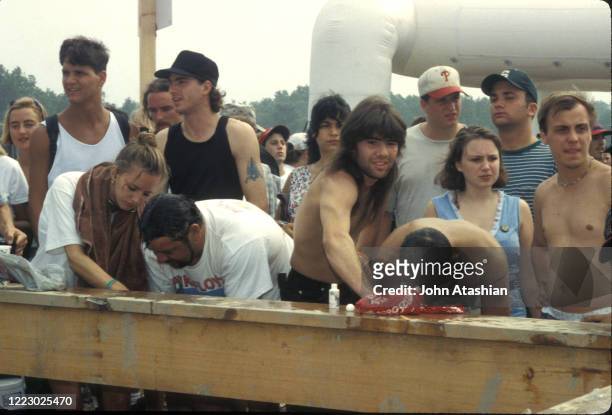 Concert fans are shown washing up at one of the few locations with running water at Woodstock 99 in Rome, New York on July 24, 1999.