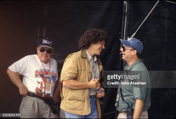 Woodstock creator and promoter Michael Lang and promoter John Scher are shown speaking on stage at Woodstock 99 in Rome, New York on July 24, 1999.