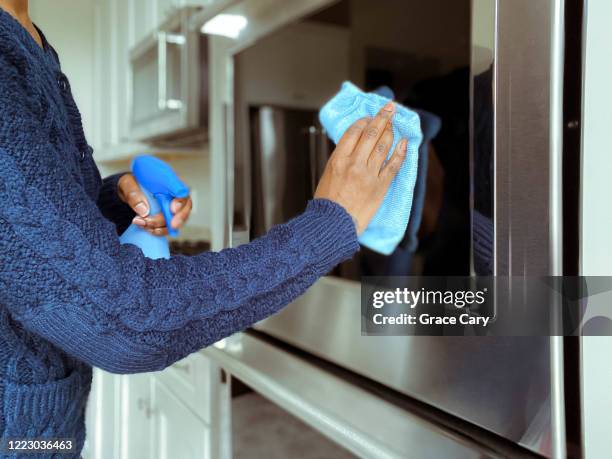woman cleans oven - clean oven stock pictures, royalty-free photos & images
