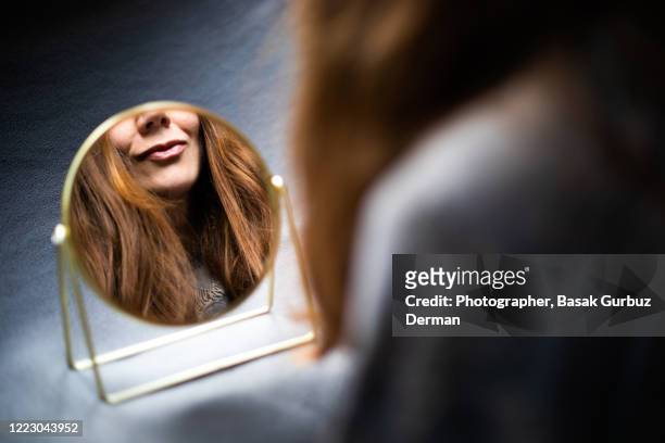 reflection of a woman looking in the mirror at herself - cream mouth stock pictures, royalty-free photos & images