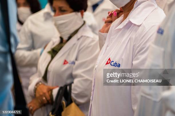 Picture shows a Cuba embroidery on the white coat of a member of a delegation of Cuban doctors after their arrival at the Martinique-Aime-Cesaire...