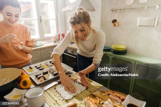 friends making sushi - making stock pictures, royalty-free photos & images