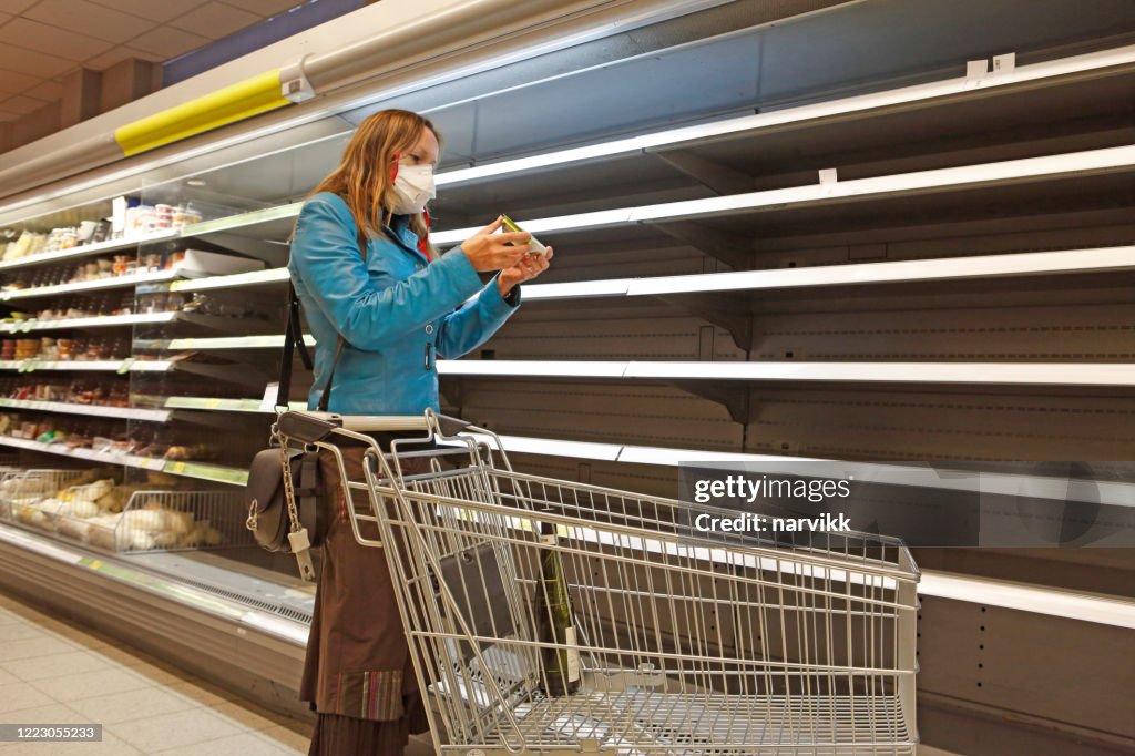 Woman in the shop at empty shelves