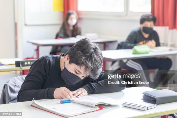 Sixth grader wears a protective face mask as he attends class for the second time since March at an elementary school in the district Kreuzberg...