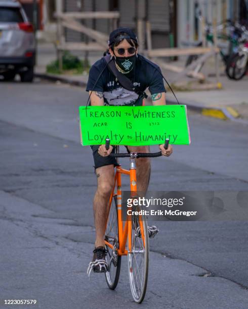 Cyclist holding a sign at the bike ride. Hundreds of cyclists congregated at Maria Hernandez Park in Bushwick for a Black Lives Matter Pride bike...