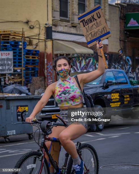 Cyclist holding a Thank You Marsha P. Johnson sign at the bike ride. Hundreds of cyclists congregated at Maria Hernandez Park in Bushwick for a Black...