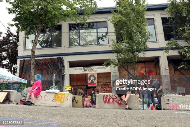 View of an abandoned Seattle police East Precinct station inside the so-called "Capitol Hill Occupied Protest" zone is guarded by a dwindling number...