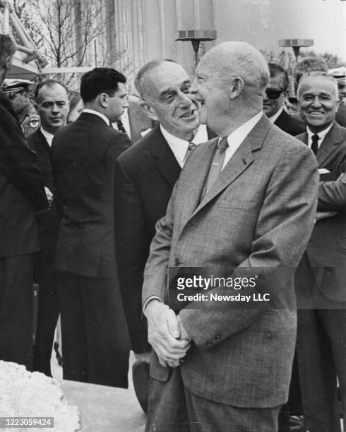 President Dwight D. Eisenhower laughs with builder Robert Moses while visiting the Churchill Pavilion at the World's Fair in Flushing Meadow, New...
