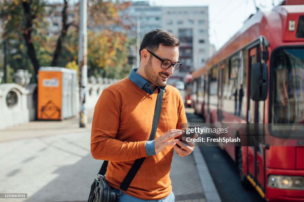 Online Business: Happy Businessman Working on the Street by Using his Smartphone