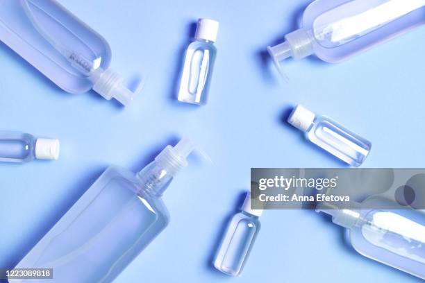 group of transparent bottles with antibacterial gel inside. - handdesinfectiemiddel stockfoto's en -beelden