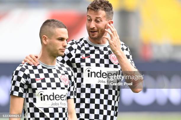 Eintracht Frankfurt players Mijat Gacinovic and David Abraham talk prior to the Bundesliga match between Eintracht Frankfurt and SC Paderborn 07 at...