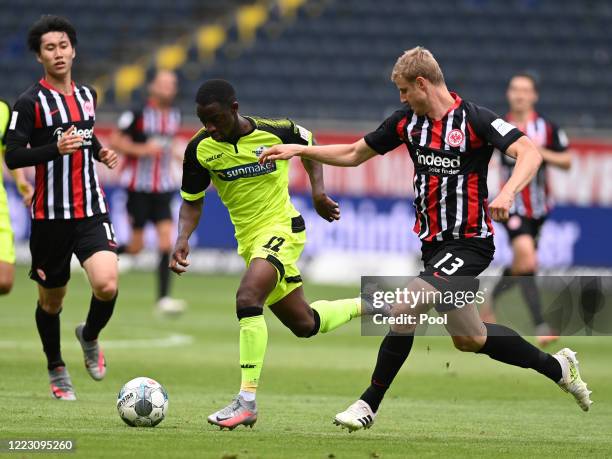 Christopher Antwi-Adjei of SC Paderborn 07 and Martin Hinteregger of Eintracht Frankfurt battle for the ball during the Bundesliga match between...