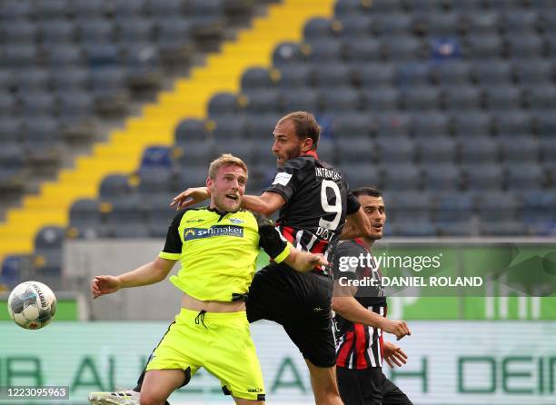 Frankfurt's Dutch forward Bas Dost vies with Paderborn's Luxembourgers defender Laurent Jans during the German first division Bundesliga football...