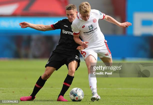 Florian Wirtz of Bayer 04 Leverkusen and Jonathan Burkardt of FSV Mainz 05 battle for the ball during the Bundesliga match between Bayer 04...