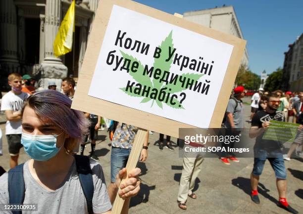 Protester holds a placard that says When will be medical cannabis in Ukraine? during so-called March of Freedom outside the President Office in Kiev....