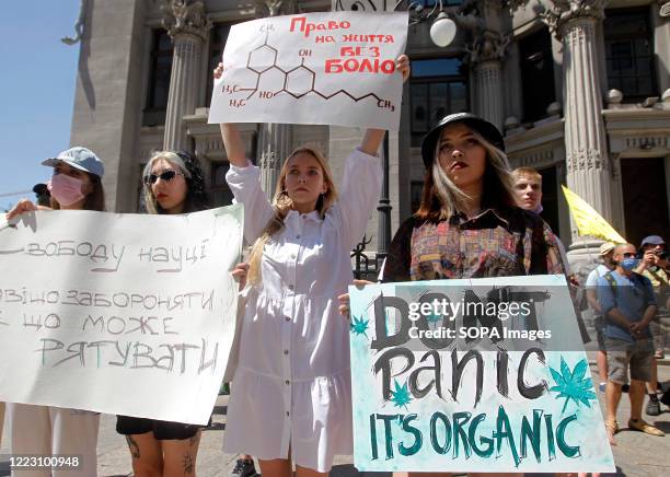 Protesters hold placards during the so-called March of Freedom outside the President Office in Kiev. The participants demand Ukrainian officials...