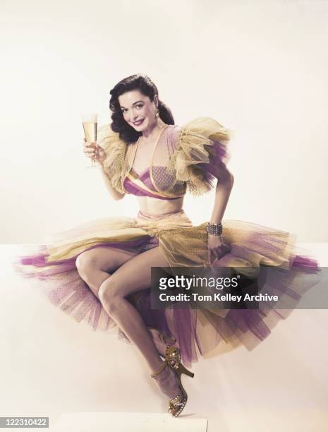 young woman in ruffled dress holding beer glass, portrait - fashion archive stockfoto's en -beelden