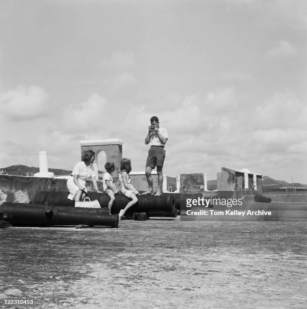 man photographing children with wife on cannon - 1963 stock pictures, royalty-free photos & images