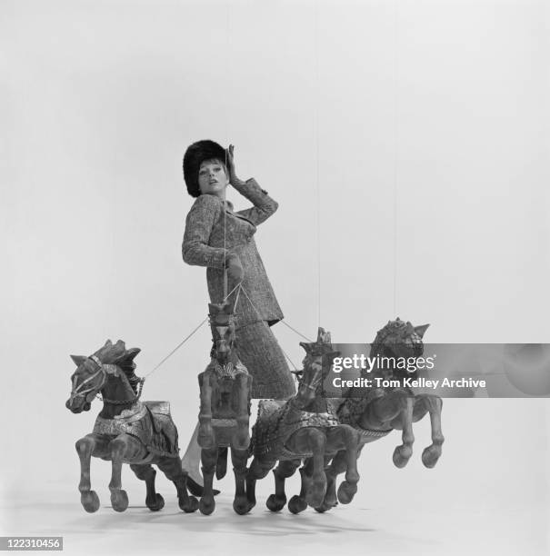 young woman holding rope of toy horses - 1963 stock pictures, royalty-free photos & images