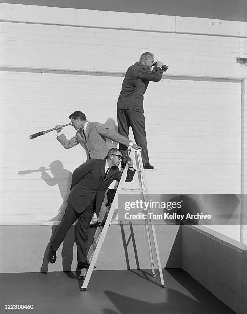 men standing on ladder with binoculars and telescope - vintage man with binoculars stock pictures, royalty-free photos & images