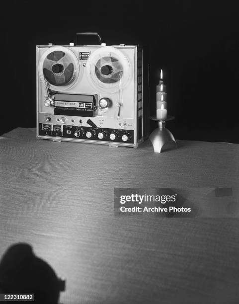 Tape recorder with candle on table