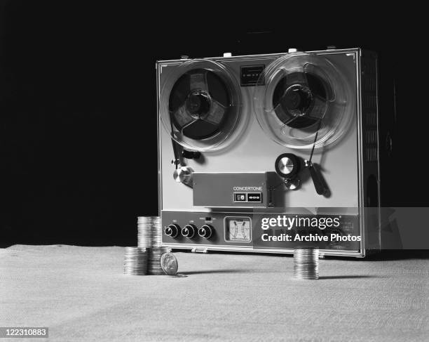 Tape recorder with stacks of coins on table