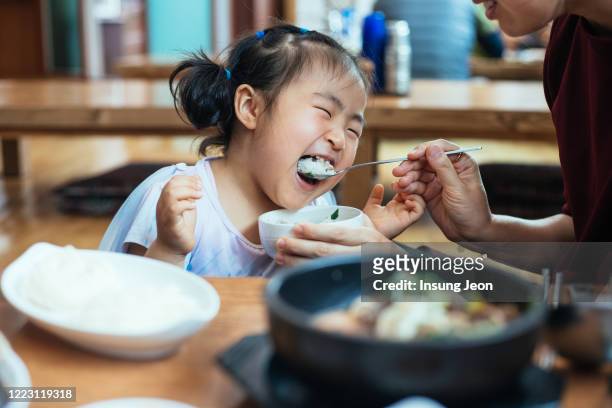 happy little girl having meal - korean food stockfoto's en -beelden
