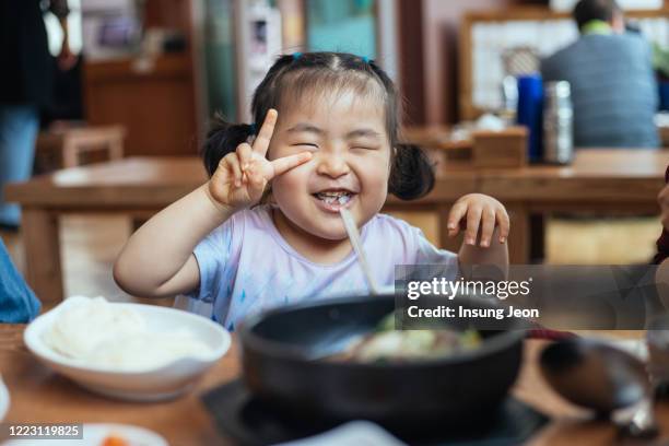 happy little girl having meal - korean food stockfoto's en -beelden