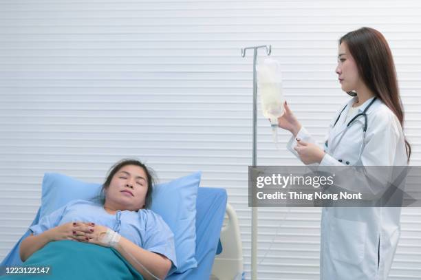 doctors encourage patients to sleep on the bed - iv drip womans hand stock-fotos und bilder