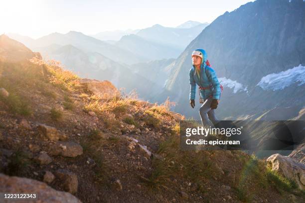 rock climbing approaching a climb along a mountain ridge - uphill stock pictures, royalty-free photos & images