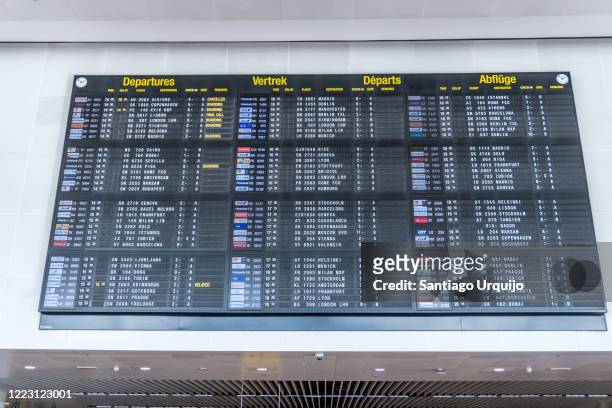 large airport departure board at zaventem airport - zaventem stock-fotos und bilder