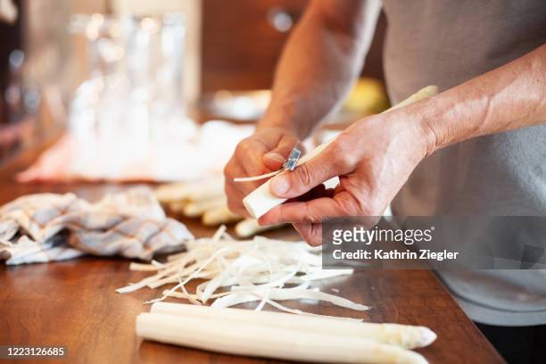 home cooking: man peeling white asparagus - peel stock-fotos und bilder