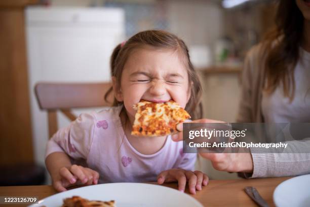 cute girl eating pizza - pizza stock pictures, royalty-free photos & images