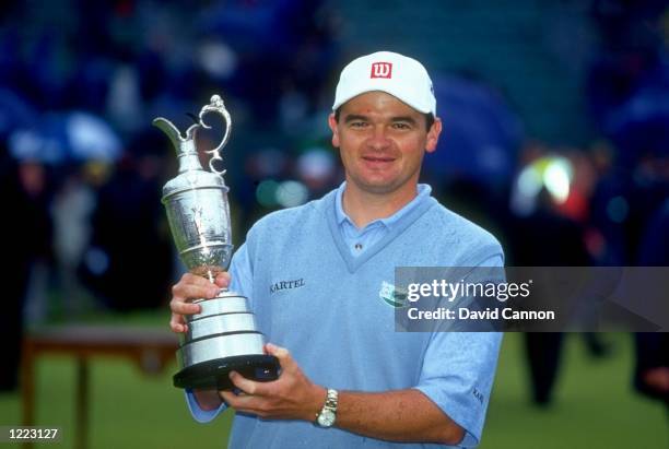 Portrait of Paul Lawrie of Scotland holds the British Open trophy after winning the event played at the Carnoustie GC in Carnoustie, Scotland. \...