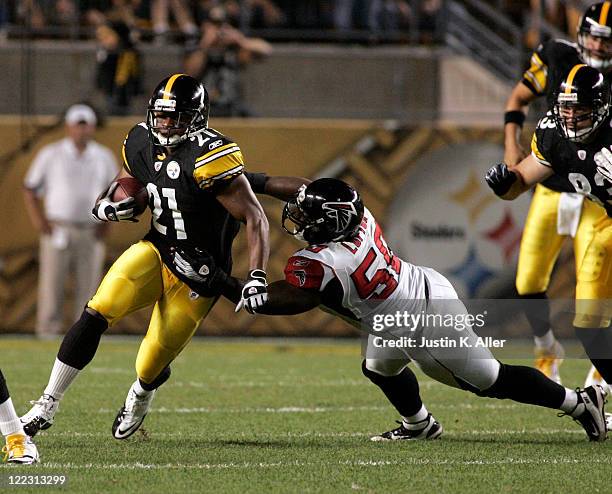 Mewelde Moore of the Pittsburgh Steelers runs the ball against Curtis Lofton of the Atlanta Falcons during a pre-season game on August 27, 2011 at...