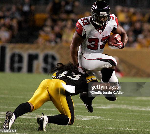 Troy Polamalu of the Pittsburgh Steelers tackles Michael Turner of the Atlanta Falcons during a pre-season game on August 27, 2011 at Heinz Field in...