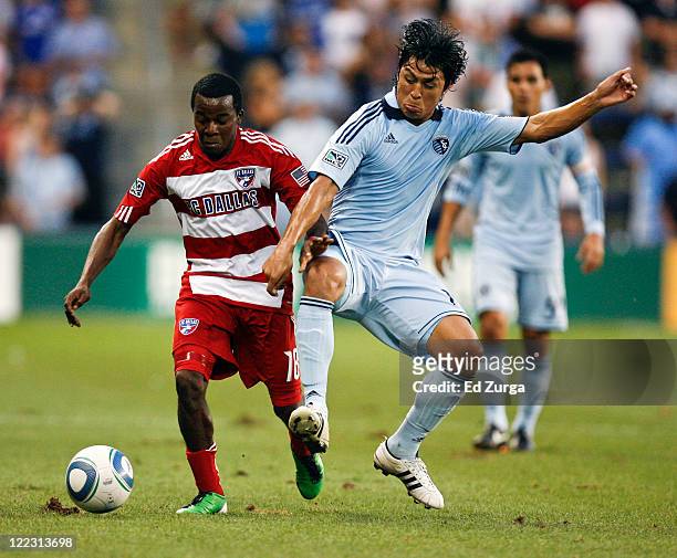Marvin Chavez of FC Dallas and Roger Espinoza of Sporting KC compete for the ball in the first half at Livestrong Sporting Park on August 27, 2011 in...