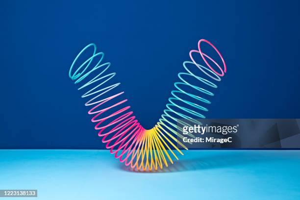 stretched coil spring toy - step walker stock pictures, royalty-free photos & images