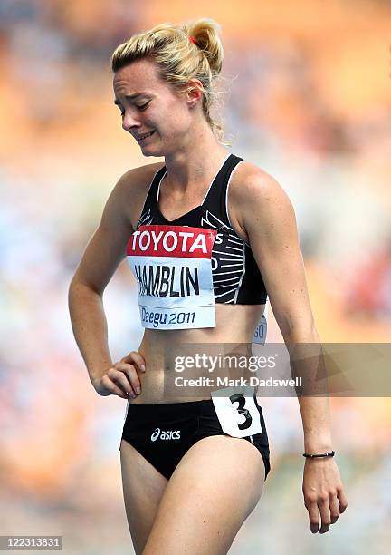 Nikki Hamblin of New Zealand cries after taking a fall during the women's 1500 metres heats next to Tandiwe Nyathi of Zimbabwe during day two of the...