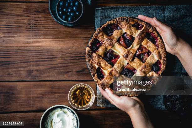 woman holding a typical german lattice fruit pie - blueberry pie stock pictures, royalty-free photos & images