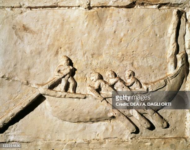Roman civilization. Relief depicting a boat with a helmsman and three rowers. From the Isola Sacra necropolis, Ostia, Lazio Region, Italy.