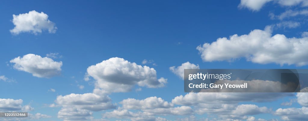 Fluffy clouds against blue sky