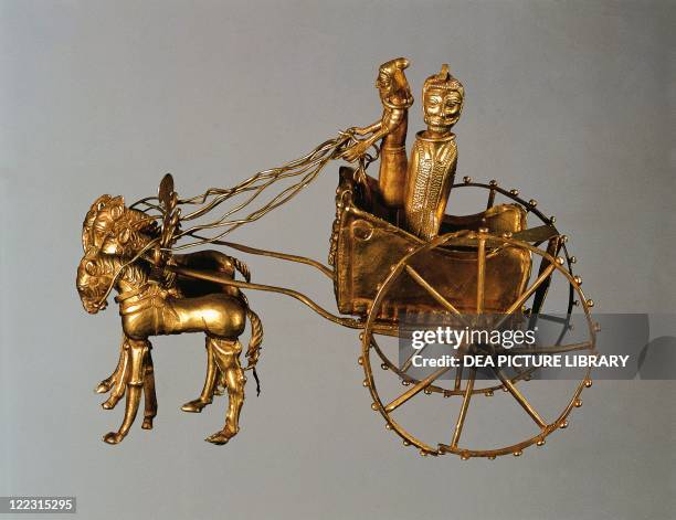 Persian civilization, Achaemenid Period, 5th-4th century b.C. Goldsmithery. Oxus treasure. Gold model of chariot drawn by four horses. Passengers are...