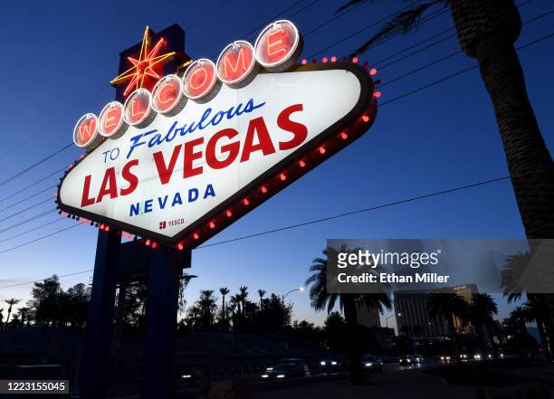Red lights flicker around the 'Welcome to Fabulous Las Vegas' sign as part of a "red takeover" coinciding with the 37th National Travel and Tourism...